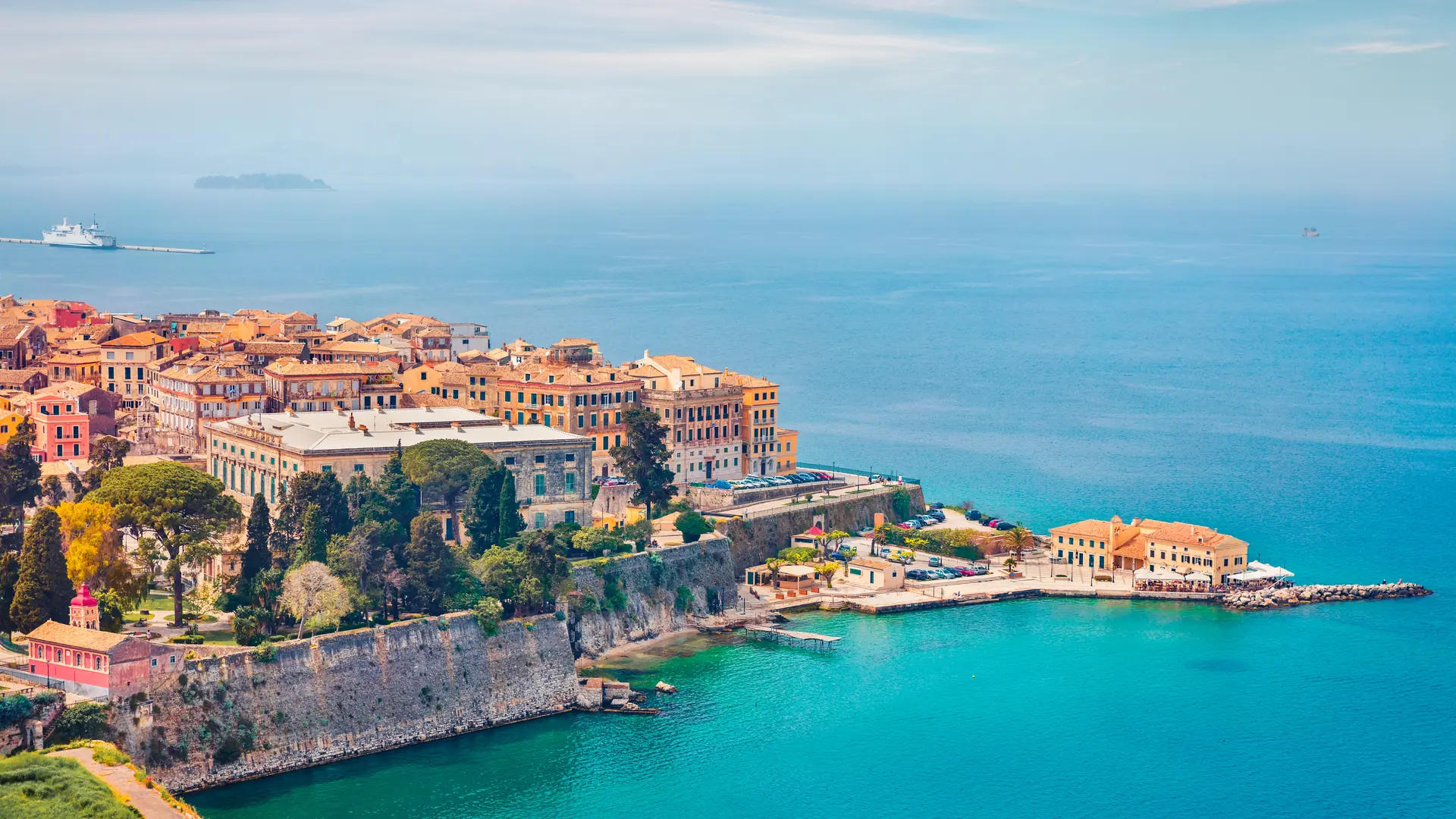 Aerial spring cityscape of capital of Corfu island. Colorful building  at the morning in Kerkira town. Amazing  seascape of Ionian Sea, Greece, Europe. Traveling concept background.