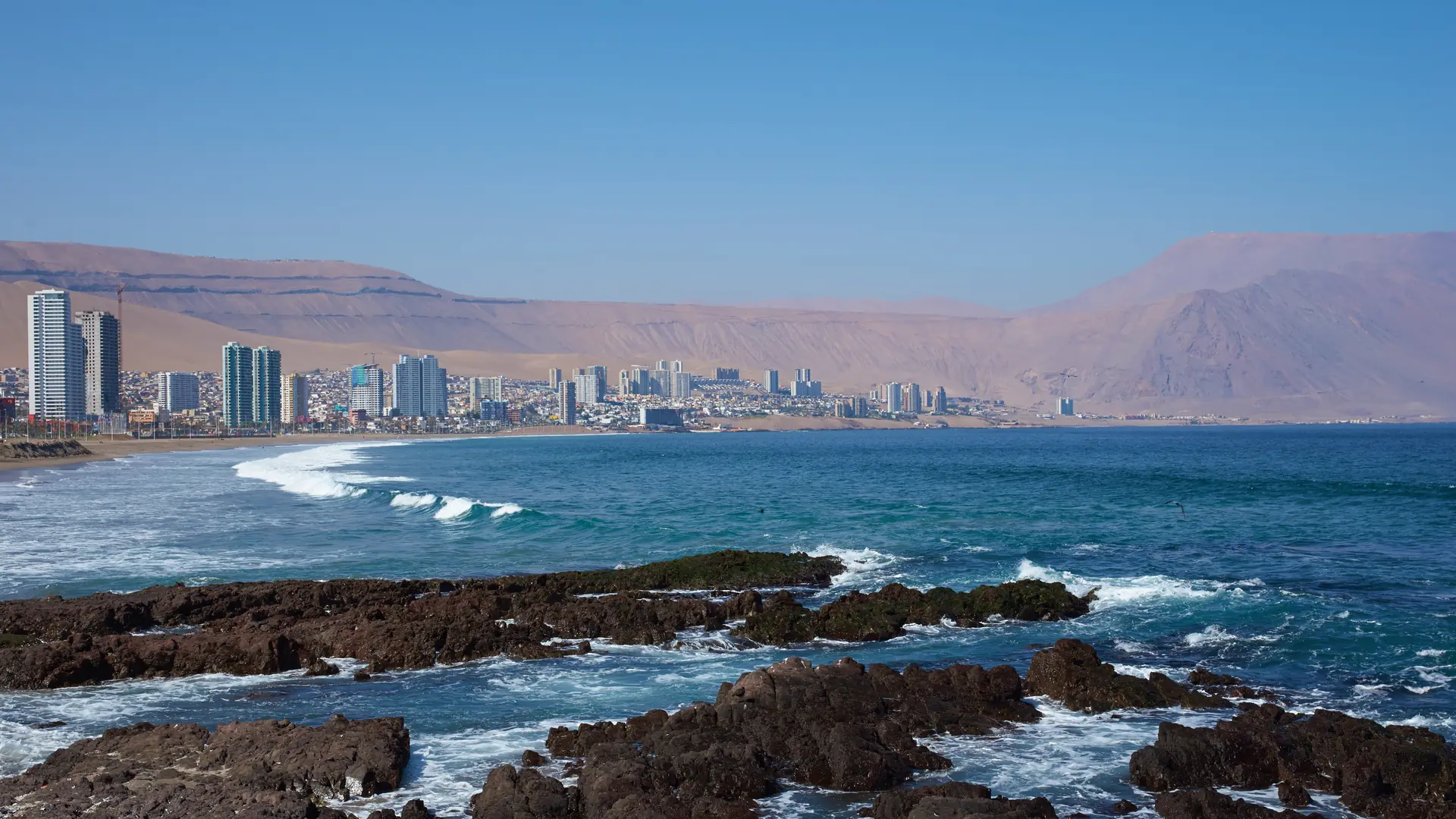 Coastal city of Iquique in northern Chile located between the waters of the Pacific Ocean and sand dunes of the Atacama Desert.