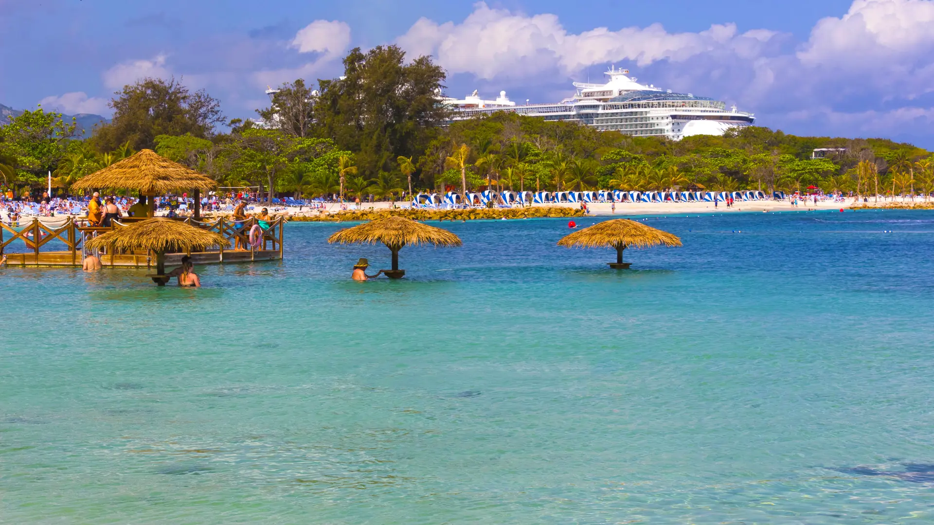 People enjoying sunny day on beach at island Labadee in Haiti