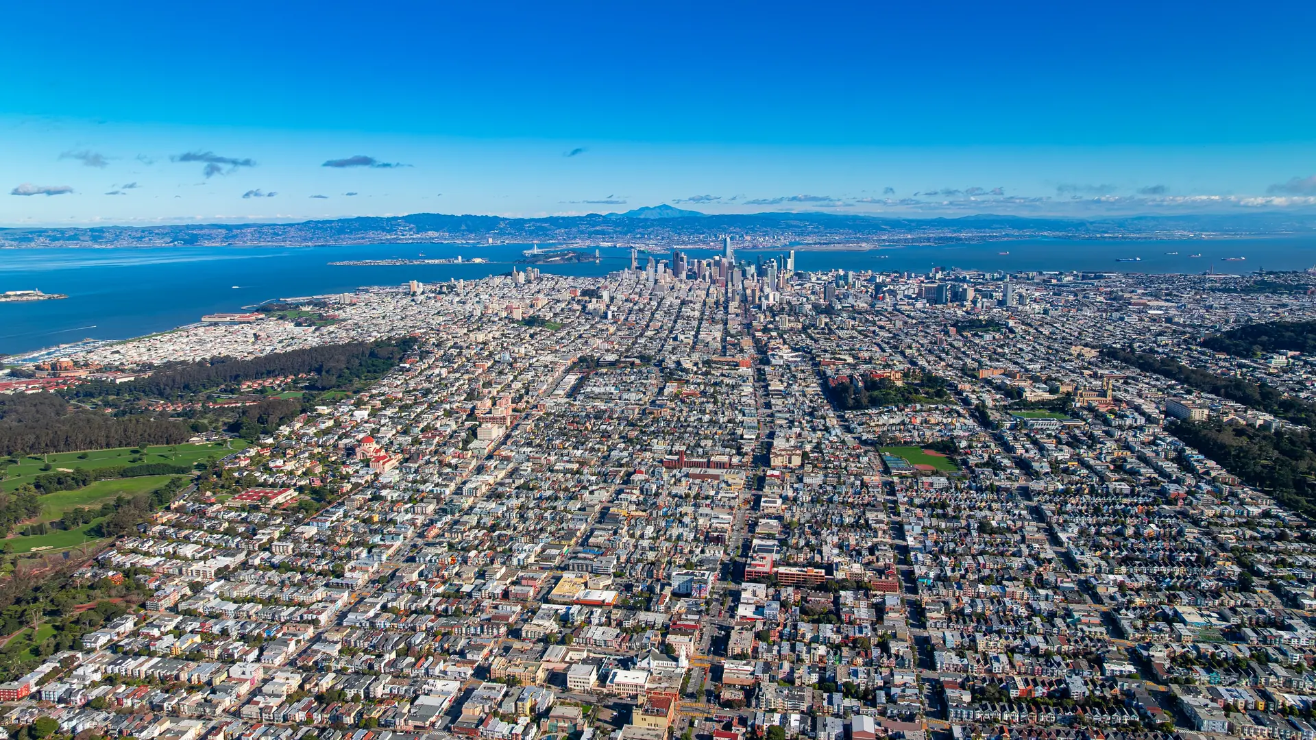 San Francisco aerial city grid daytime. Daytime aerial view of San Francisco city grid stretching toward downtown skyline.