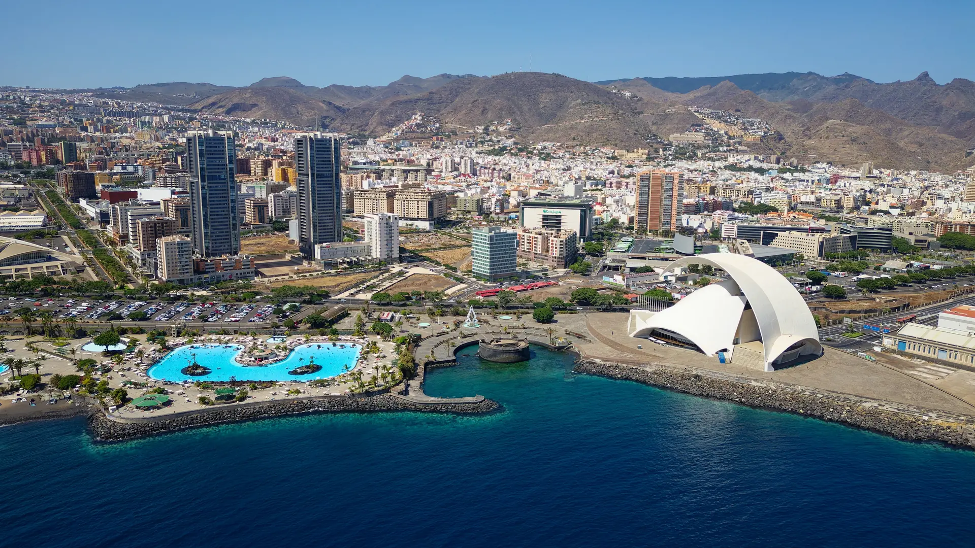 Aerial view of Santa Cruz de Tenerife, in the Canary Islands, Spain. Resorts and pools next to the Atlantic ocean. Famous tourist destinations. Island in the Atlantic ocean.