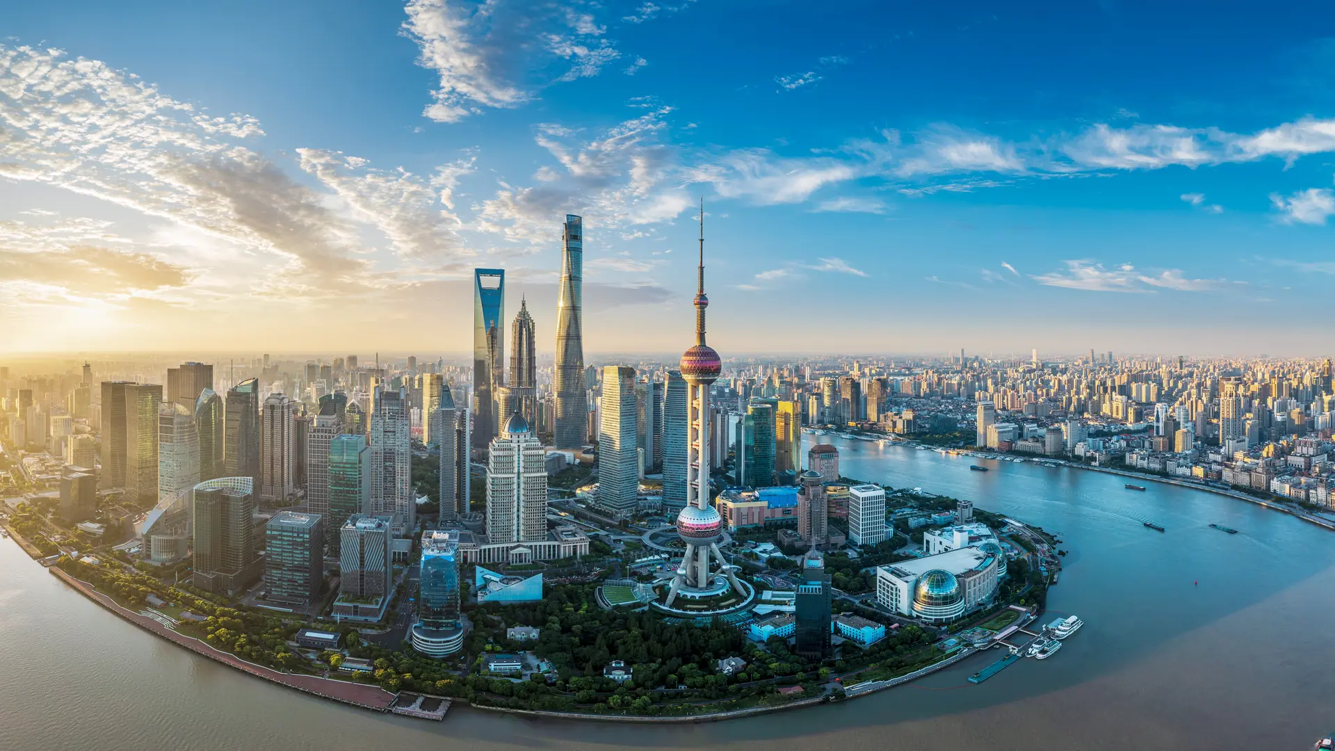 Aerial view of the city skyline with modern skyscrapers at sunrise in Shanghai, China.