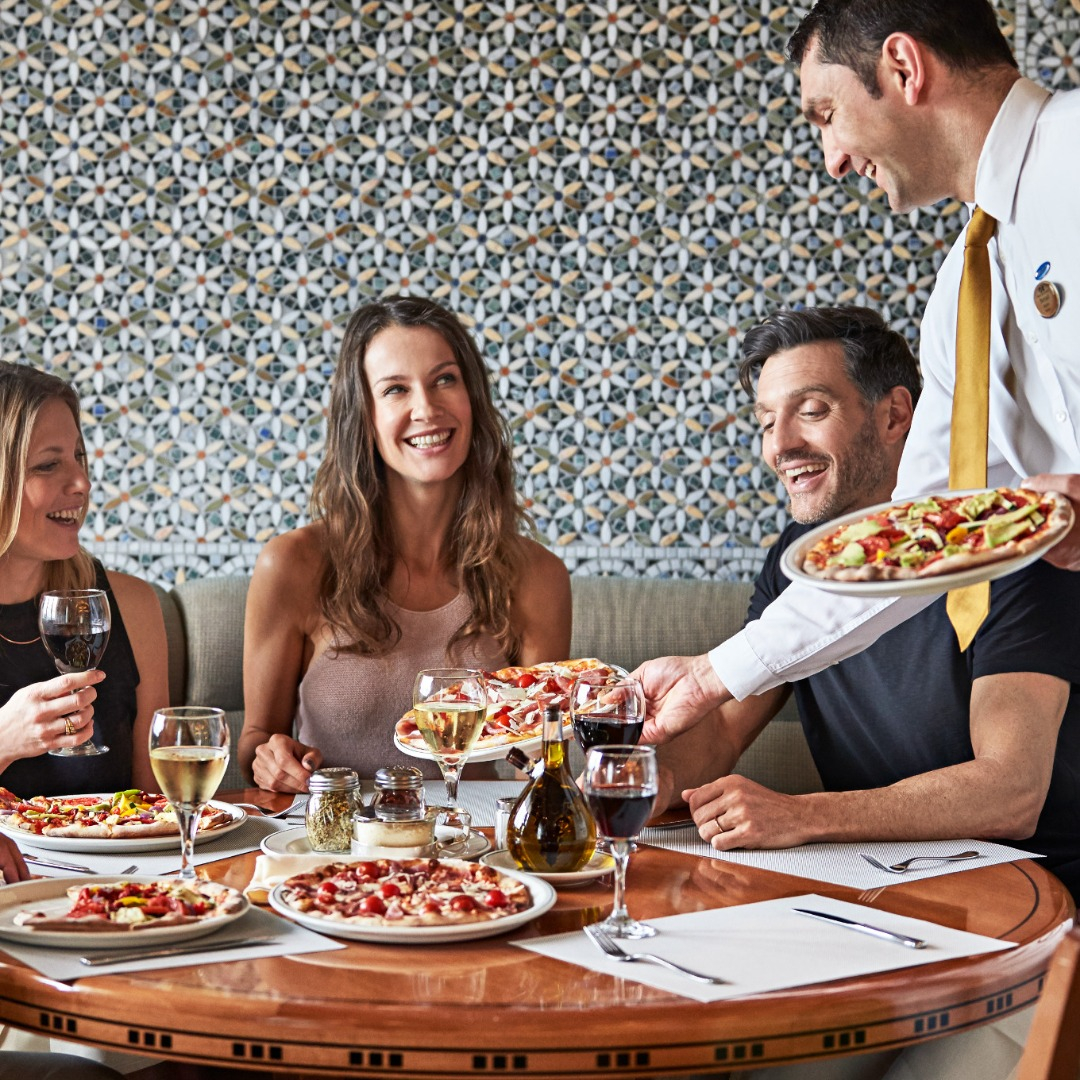 Waiter Serving Pizza