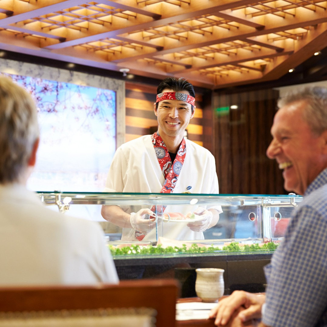 Sushi chef smiling with couple