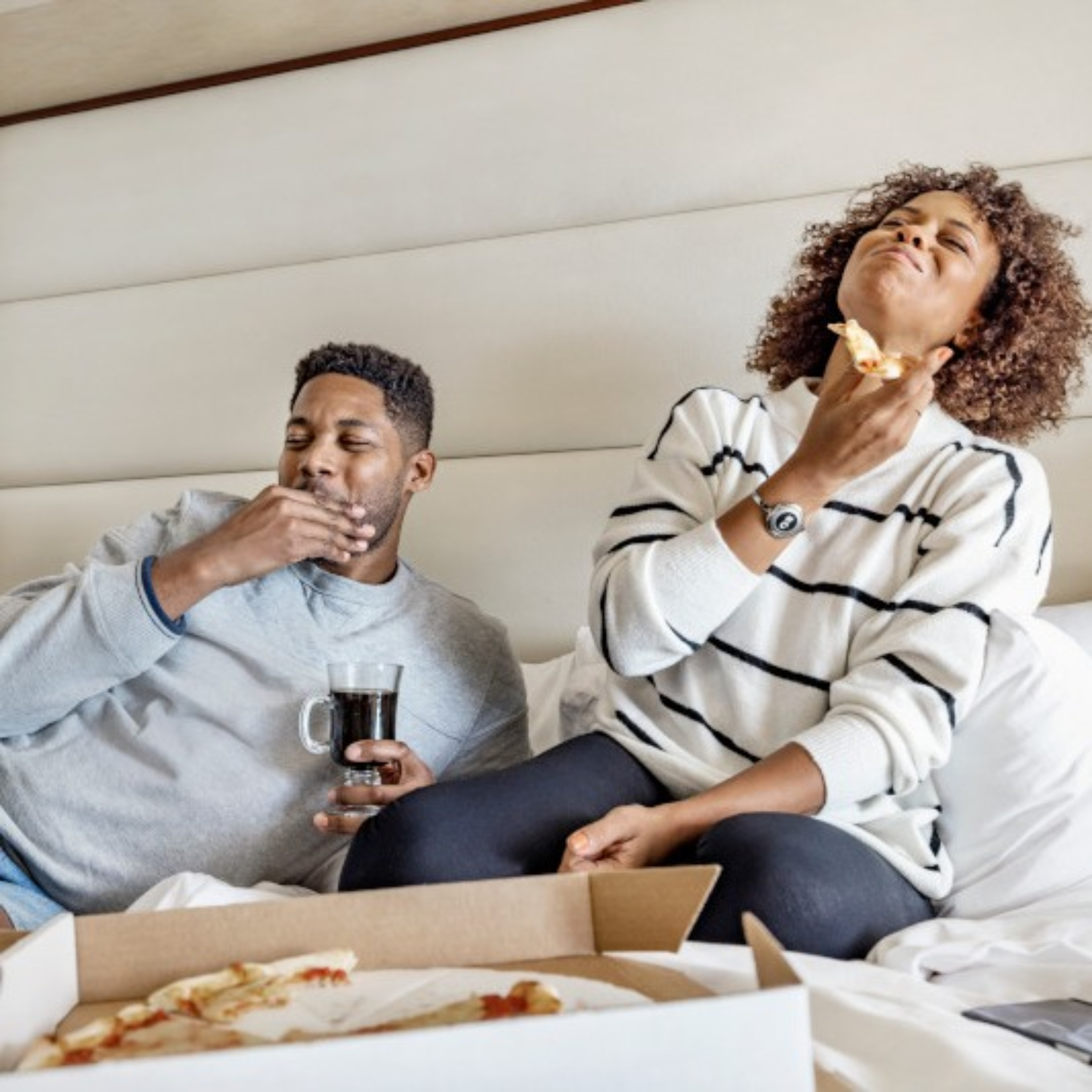 Couple eating in bed