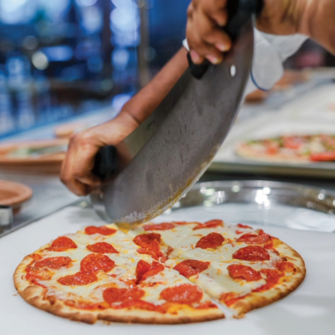 Pizza being sliced